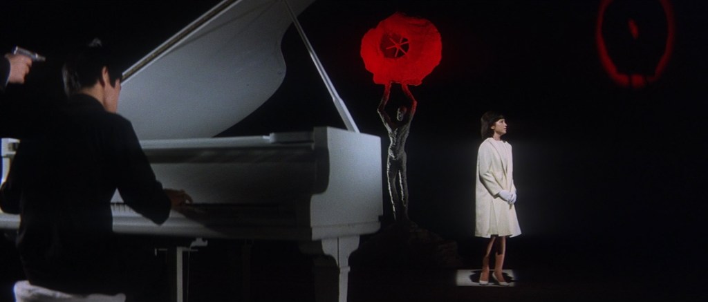 Man forced to play the piano for a female singer