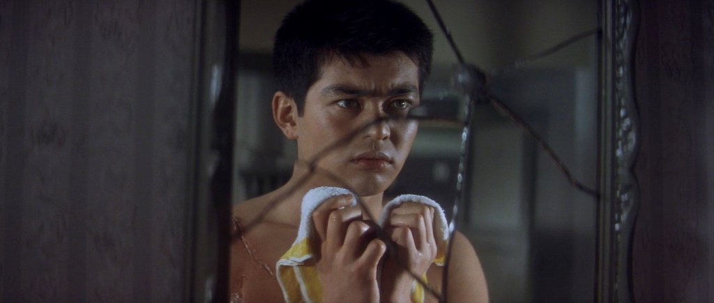 Man looks in a cracked mirror